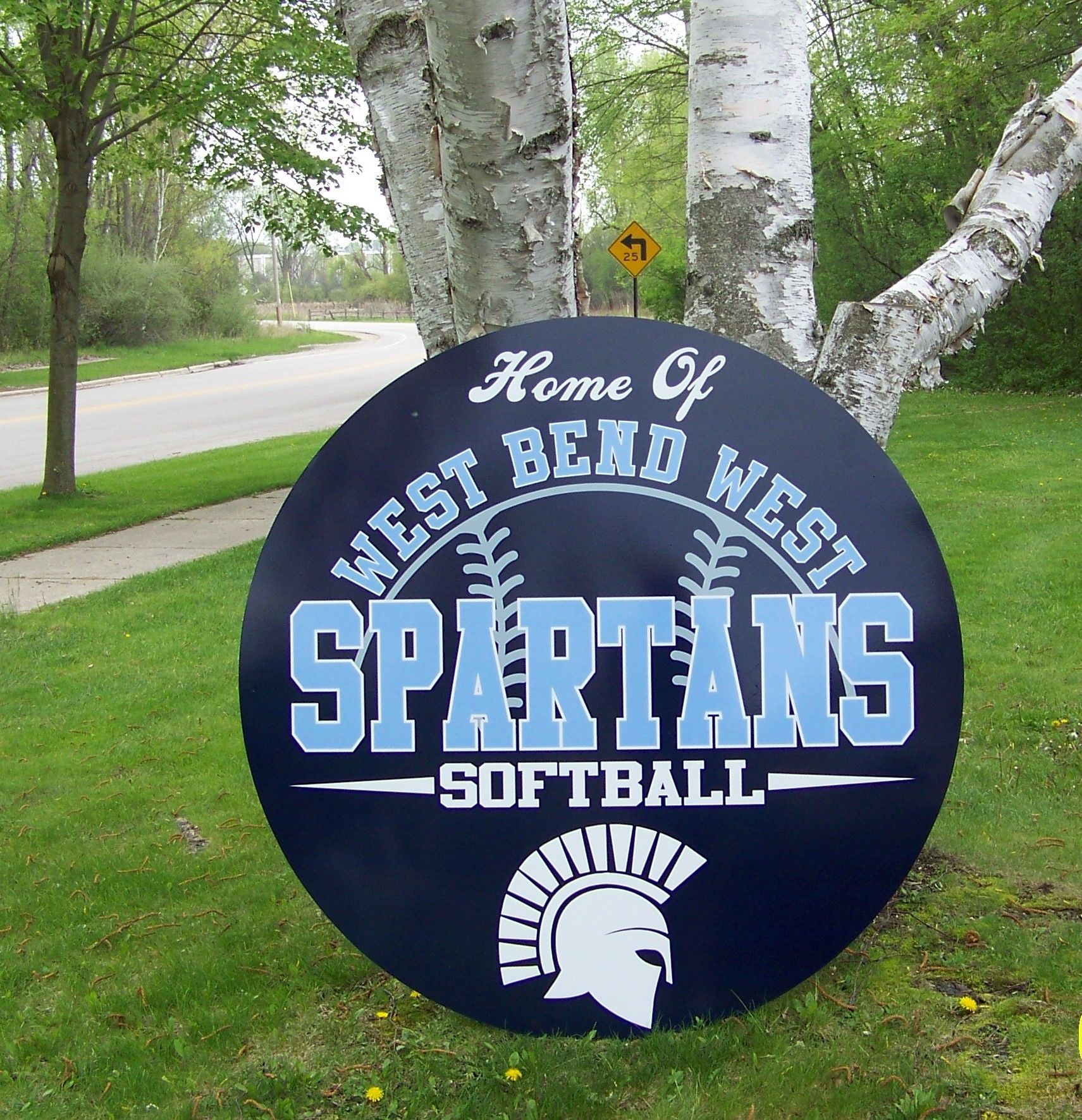 A sign for the west bend west spartans softball team