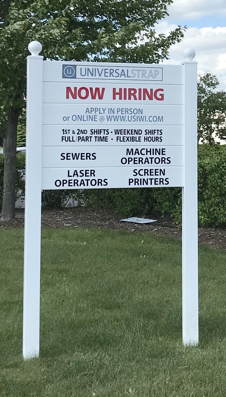 A white sign that says