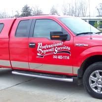 Red truck with a cap and business logo, Professional Drywall Services.