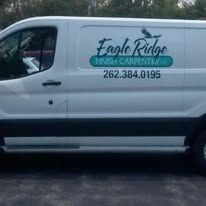 White work van with Eagle Ridge Finish Carpentry logo and phone number.