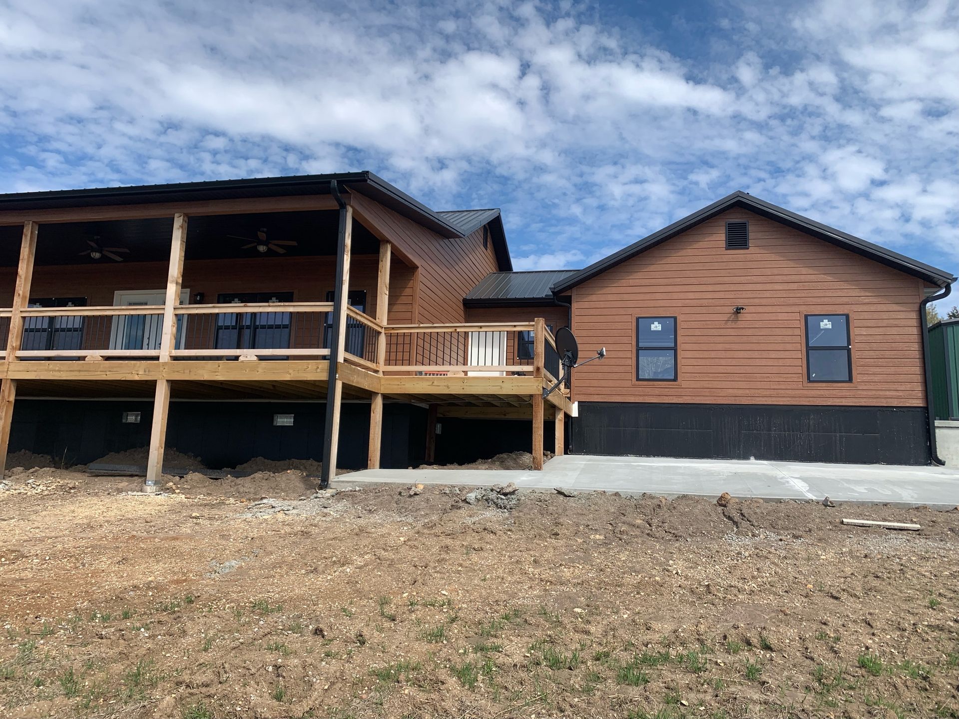 A large house with a large deck on the side of it