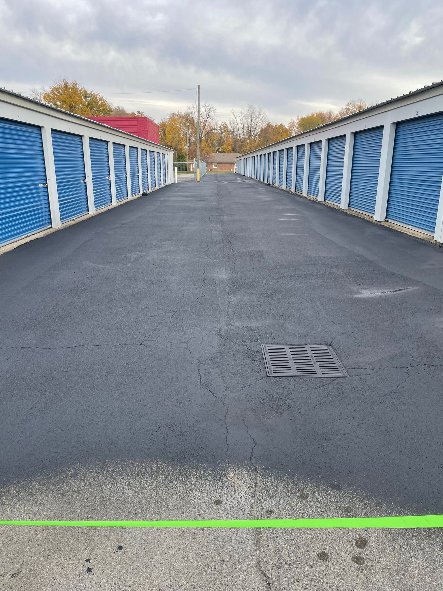 A row of storage units lined up on the side of a road.