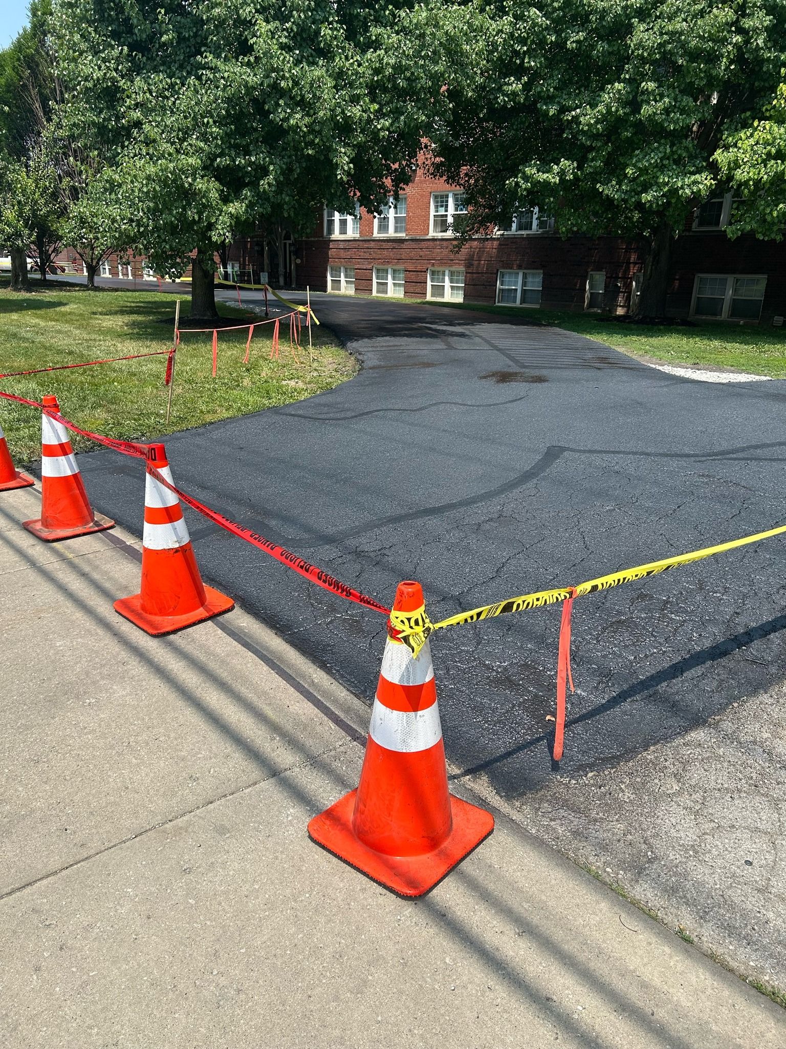 A row of orange and white traffic cones sitting on the side of a road.