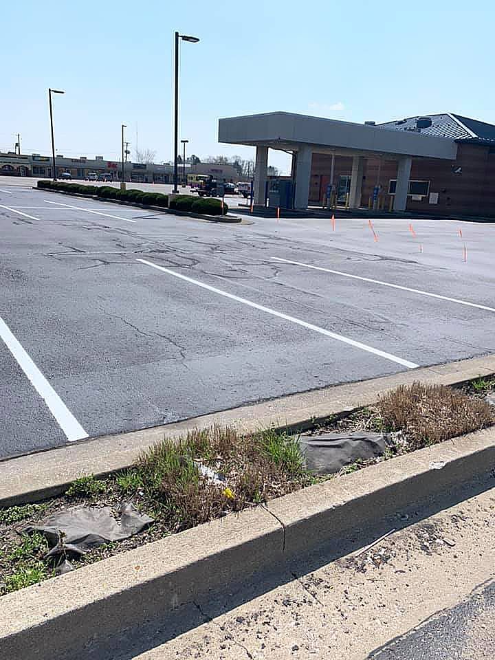 A parking lot with a building in the background.