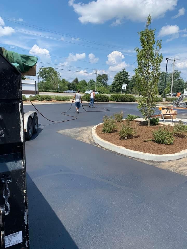 A group of people are working on a parking lot.