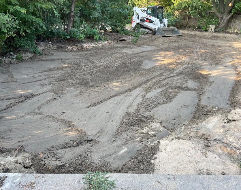 A bulldozer is moving dirt in a dirt field