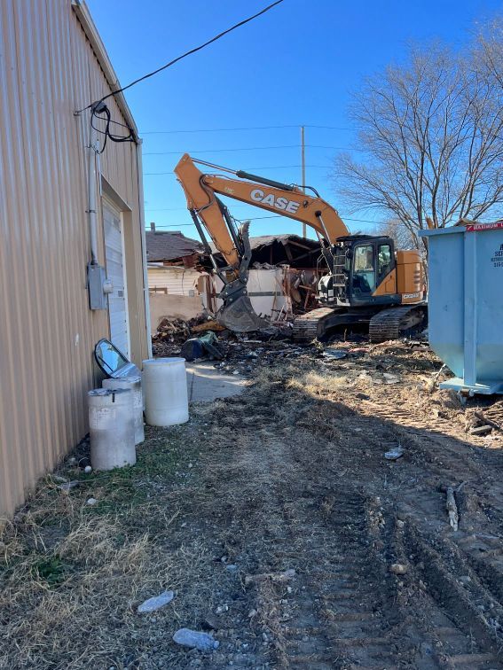 A case excavator is being used to demolish a building.