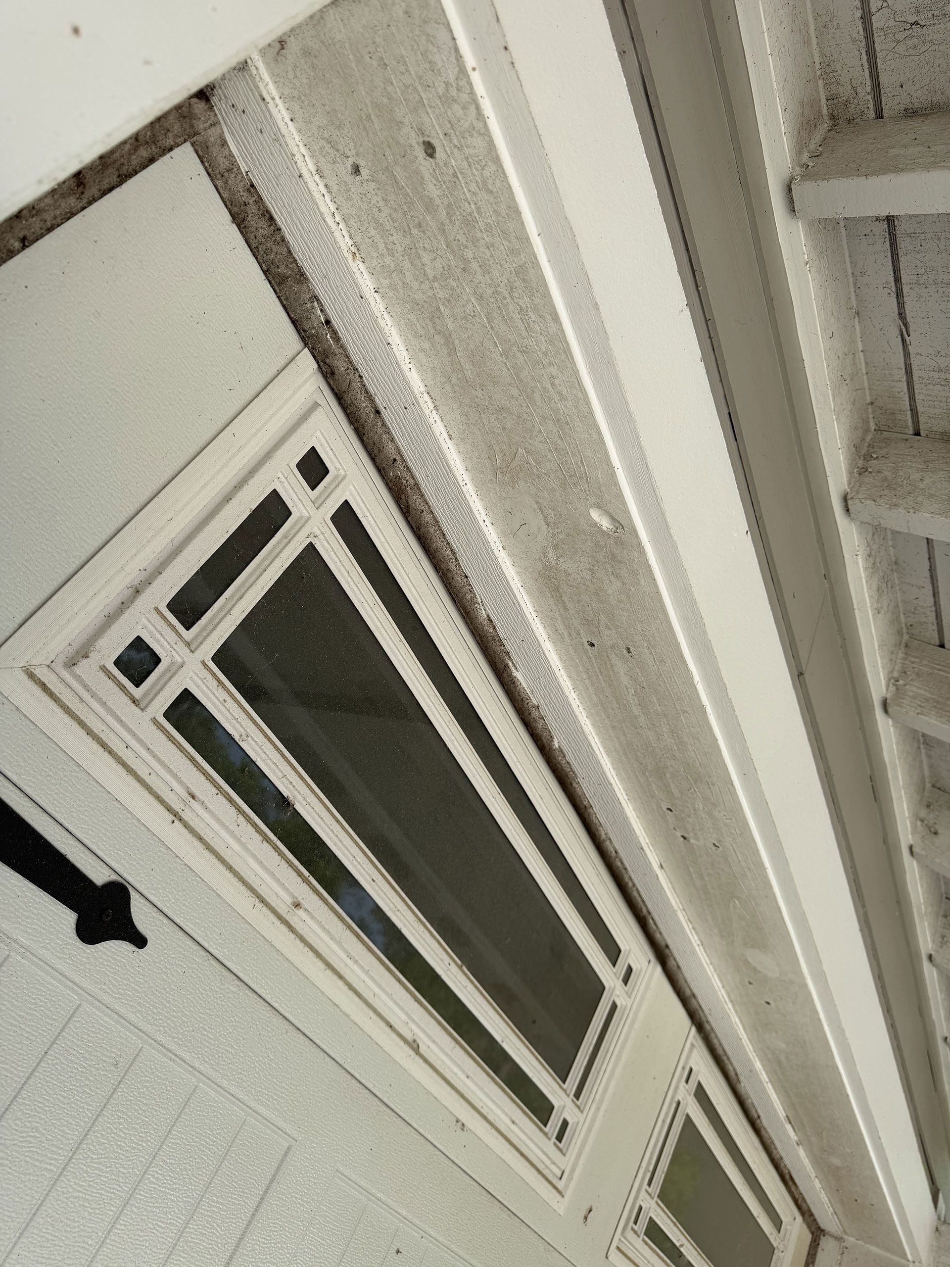 Tilted view of a ceiling vent and fluorescent light fixture in a beige interior room