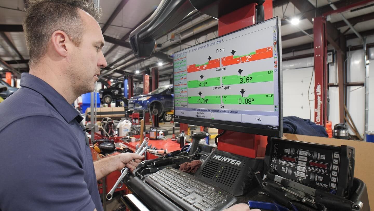A man is working on a computer in a garage.