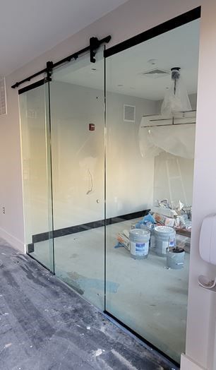 A room with a two mirror barn door