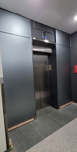A large elevator in a building with a stainless steel door