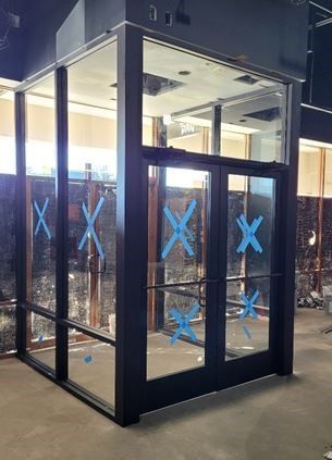 A building entrance made with glass windows and doors