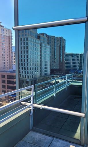 A balcony with a railing and a glass wall to cover the edge
