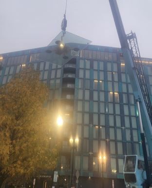 A large building with a crane in front of it