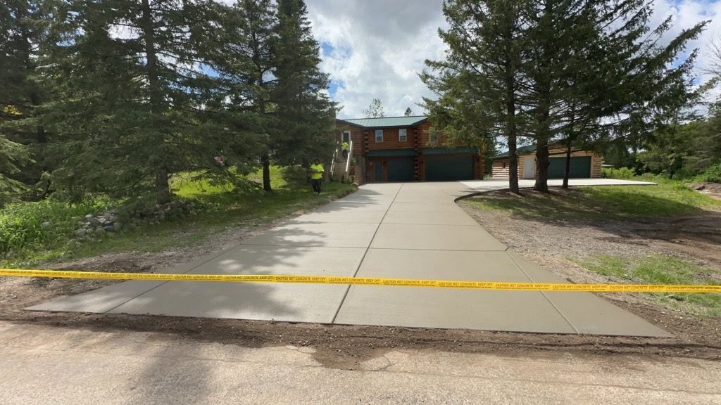 A concrete driveway with a yellow tape around it
