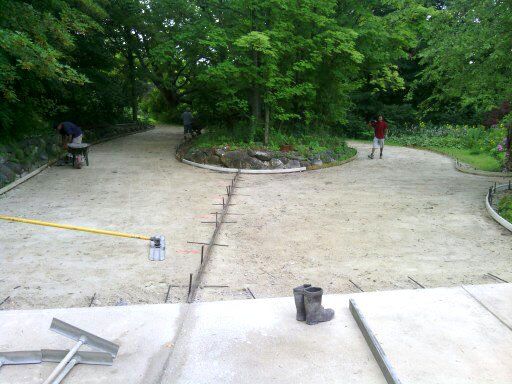 A person is walking down a dirt road in a park.