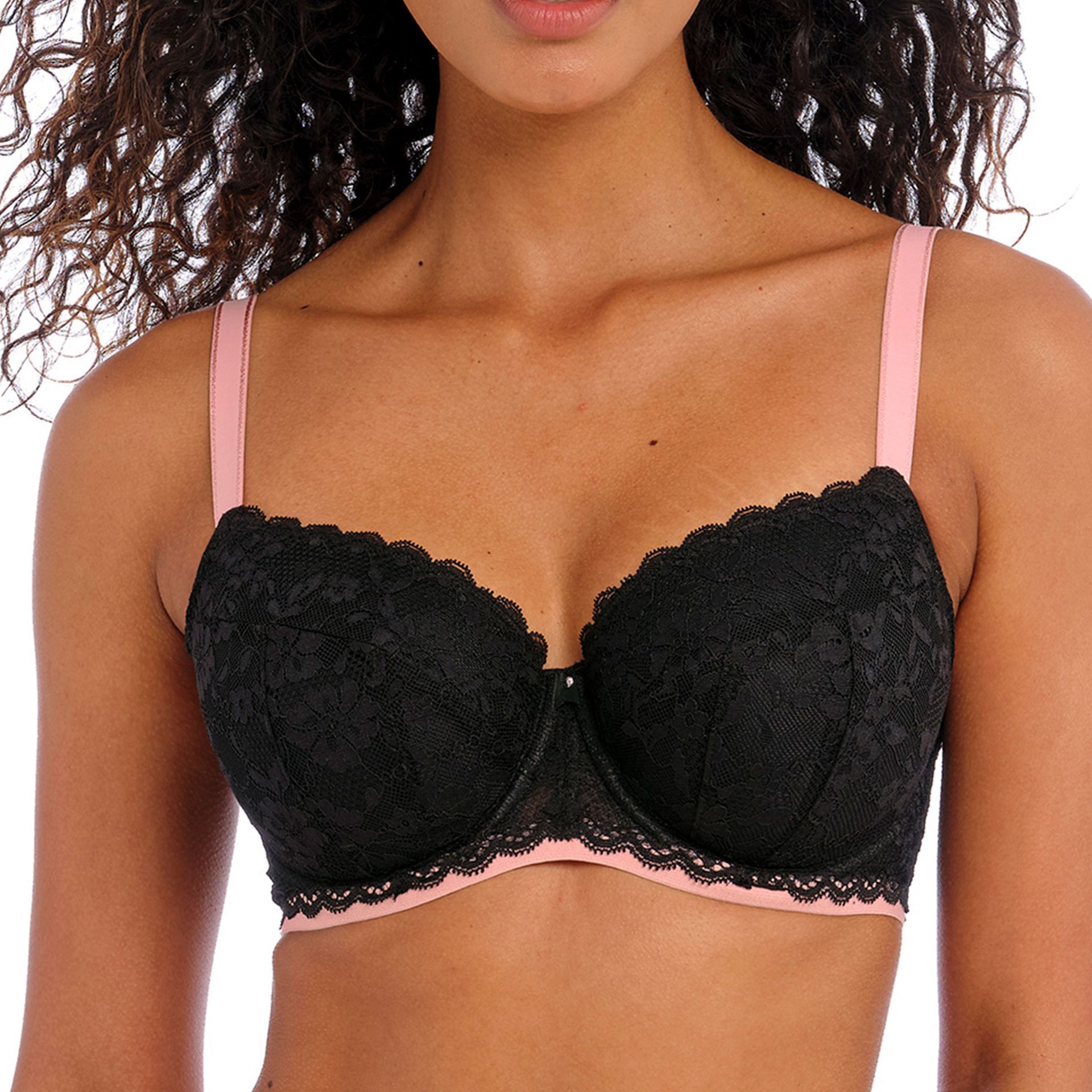 A woman is wearing a black bra with pink straps