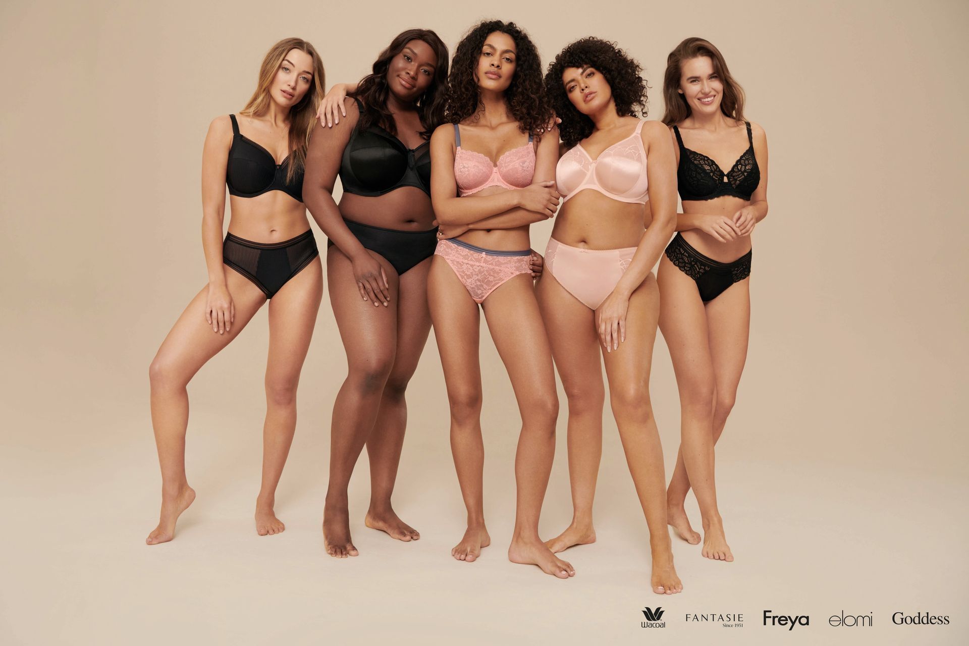 A group of women in underwear are posing for a picture.