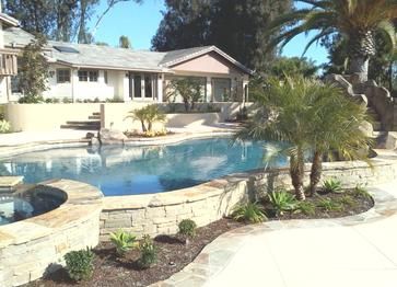 A house with a large swimming pool in front of it
