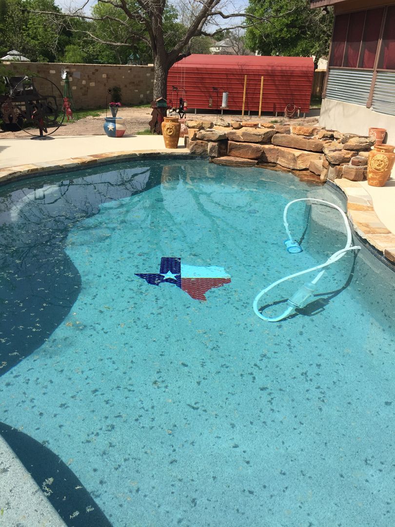 A stone fireplace is built into a stone wall