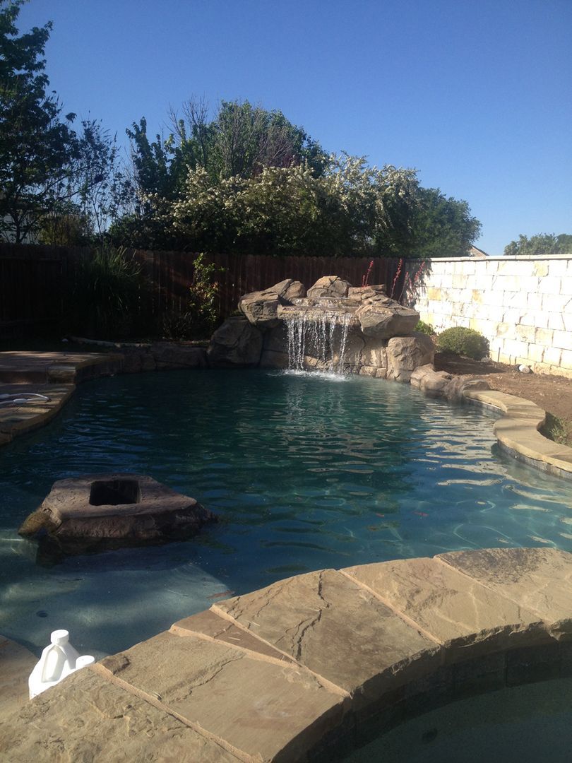 There is a waterfall in the middle of the pool.