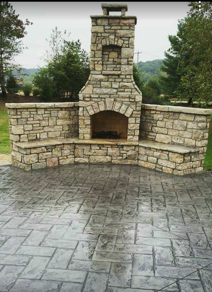 A stone fireplace is built into a stone wall