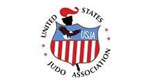 US Judo Association logo: shield with torch, eagle, and American flag stripes,