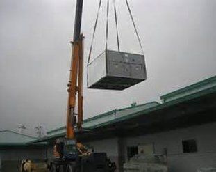Crane carrying a metal box