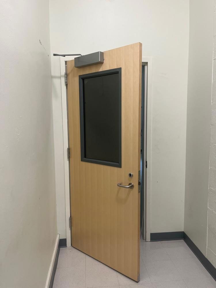 Fireproof door with a stainless steel handle and a window