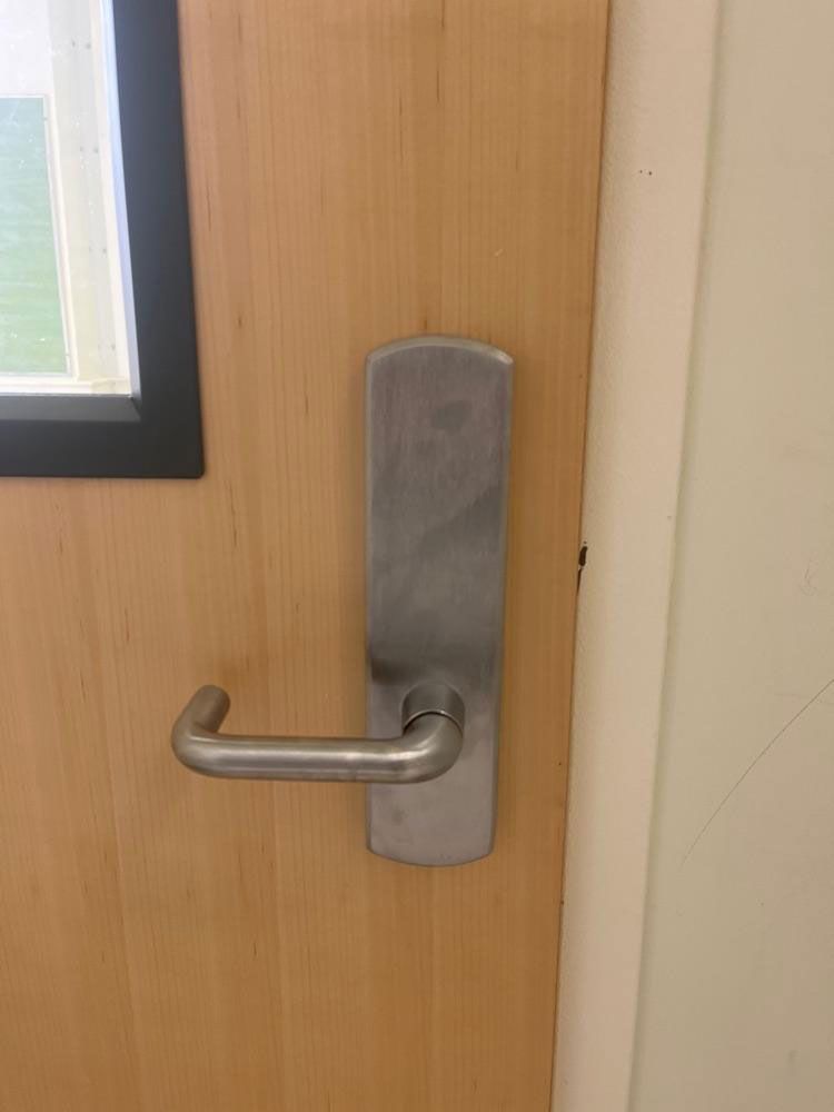 A close up of a door handle on a fireproof door