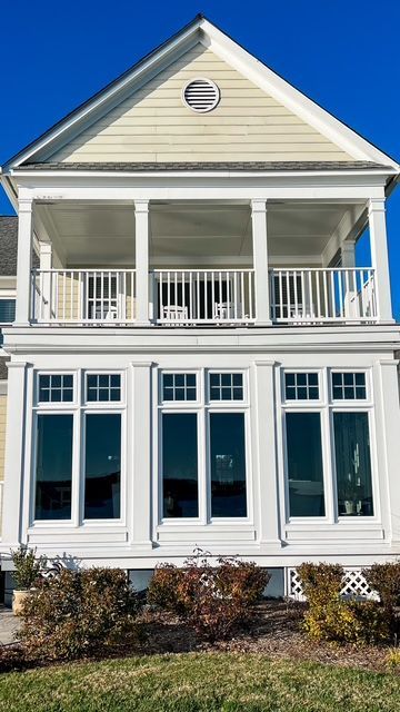 A large white house with a lot of windows and balconies