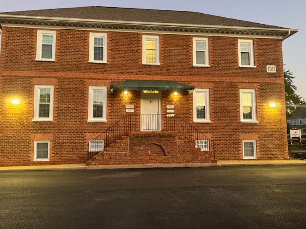 A large brick building with a lot of windows and stairs