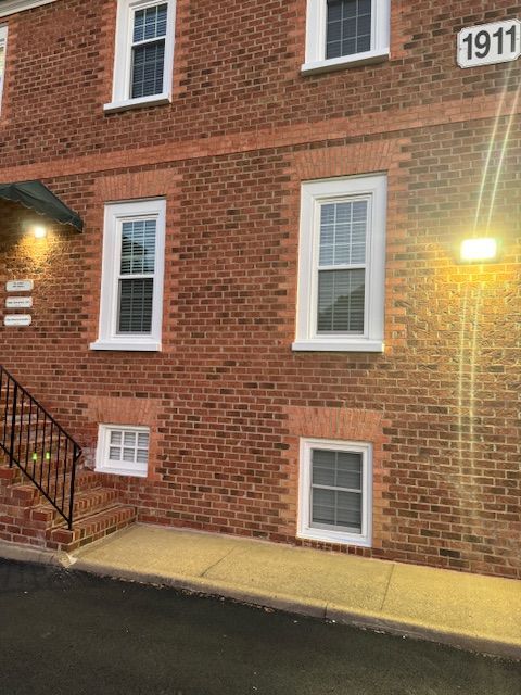 A brick building with stairs and a sign that says 1911 on it.