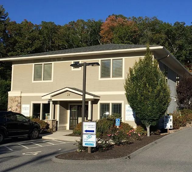 A large house with a car parked in front of it