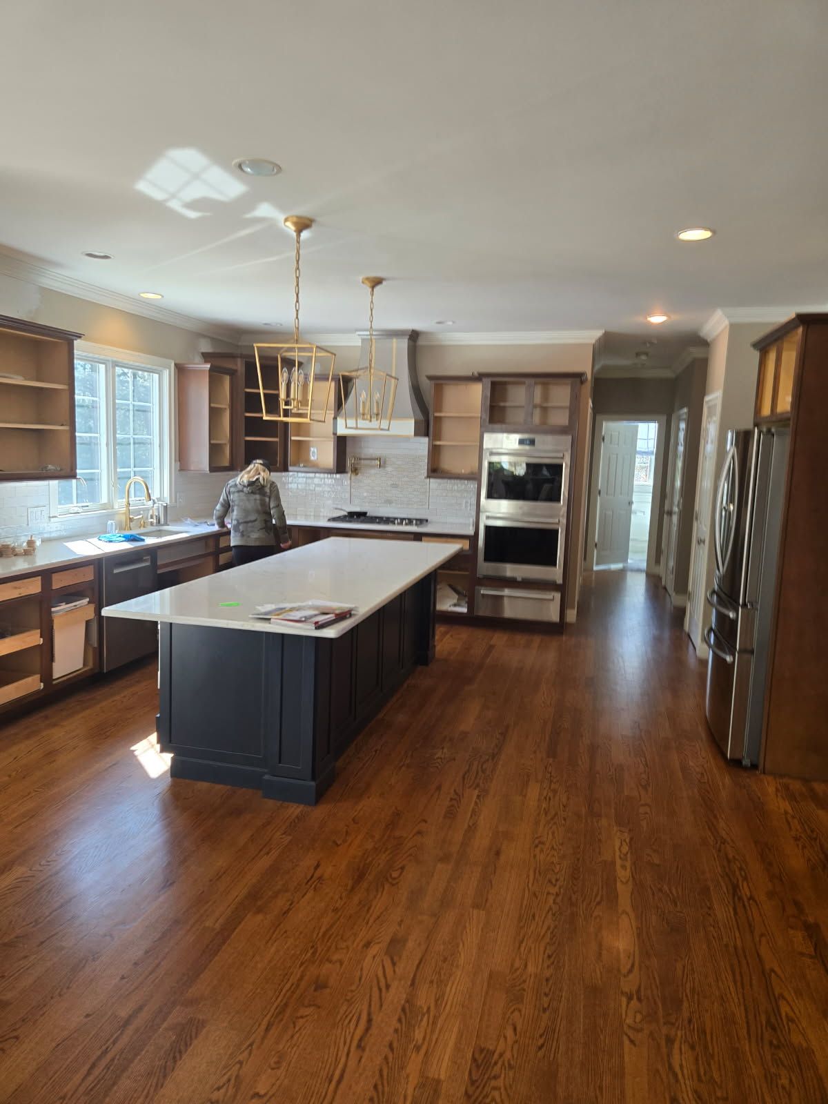 A large kitchen with hardwood floors and stainless steel appliances.