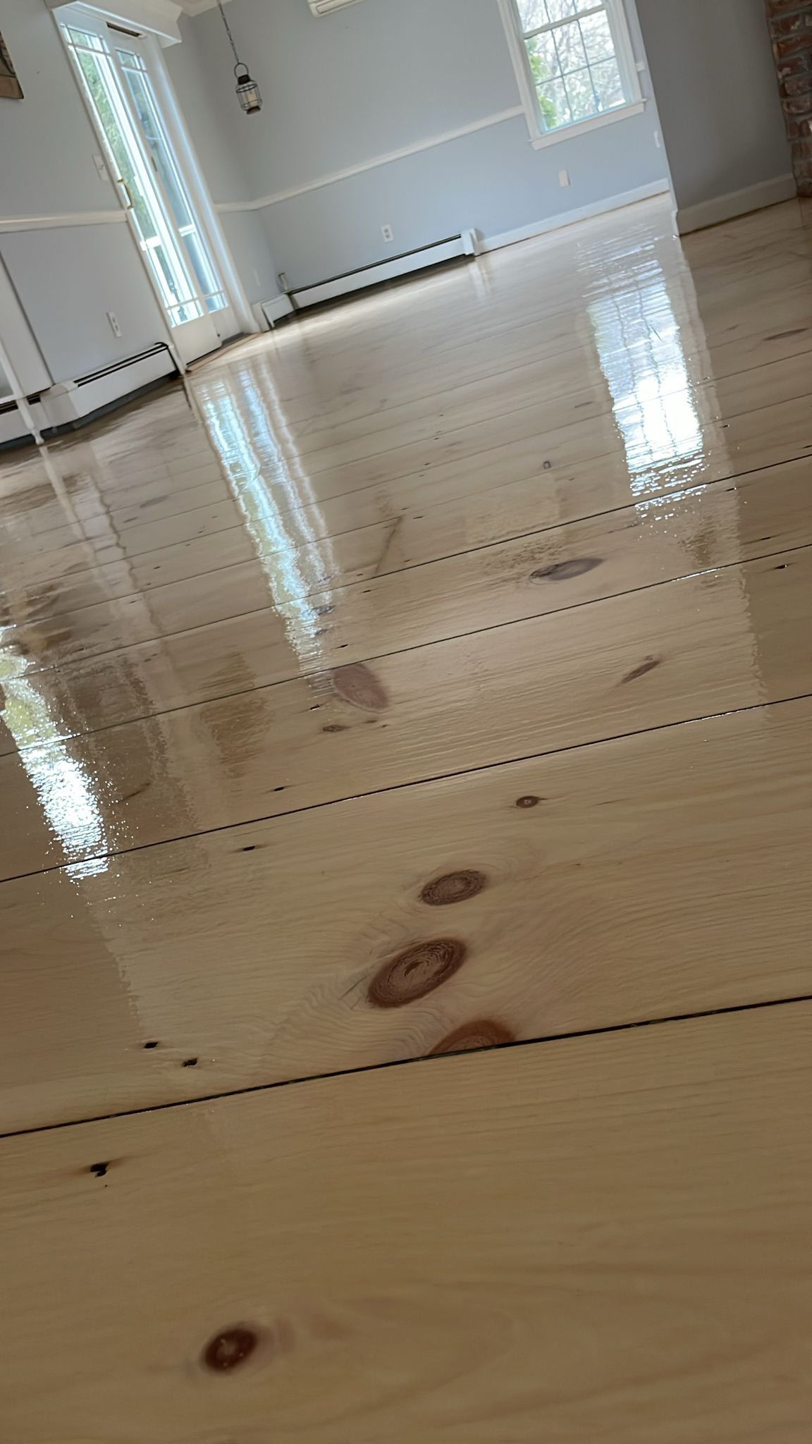 A wooden floor in a room with a window.
