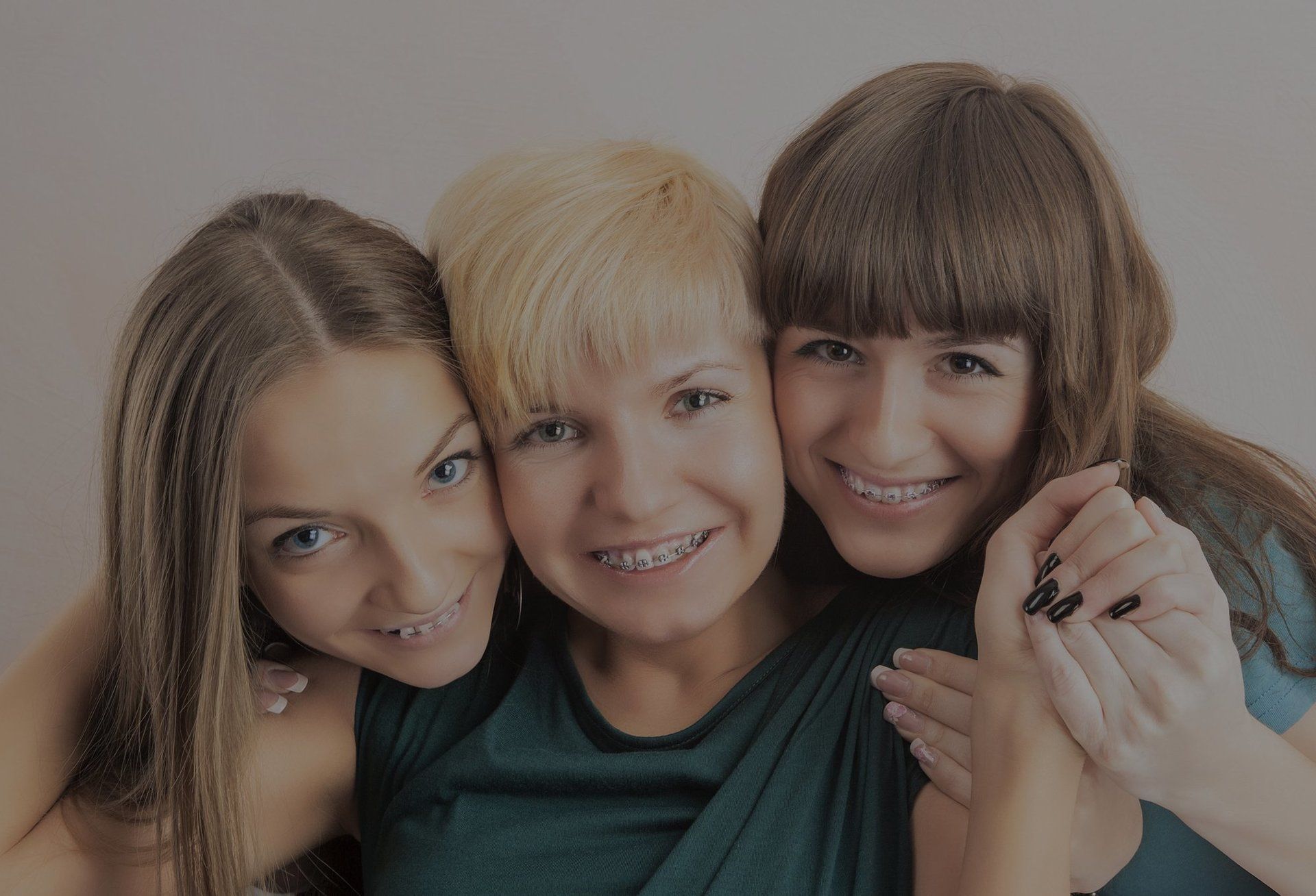 Mother with two daughters having the same braces