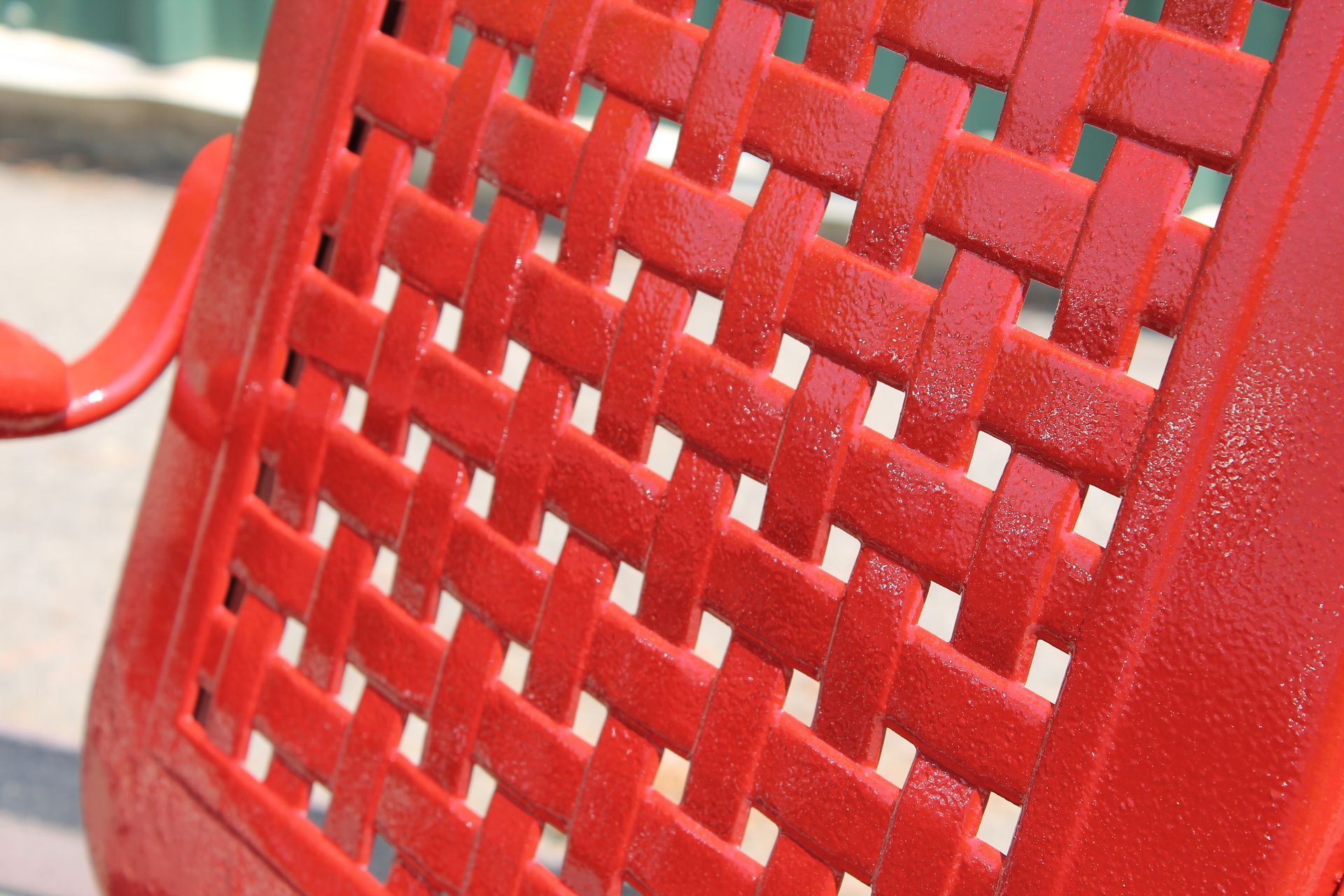 A close up of a red chair with a woven pattern