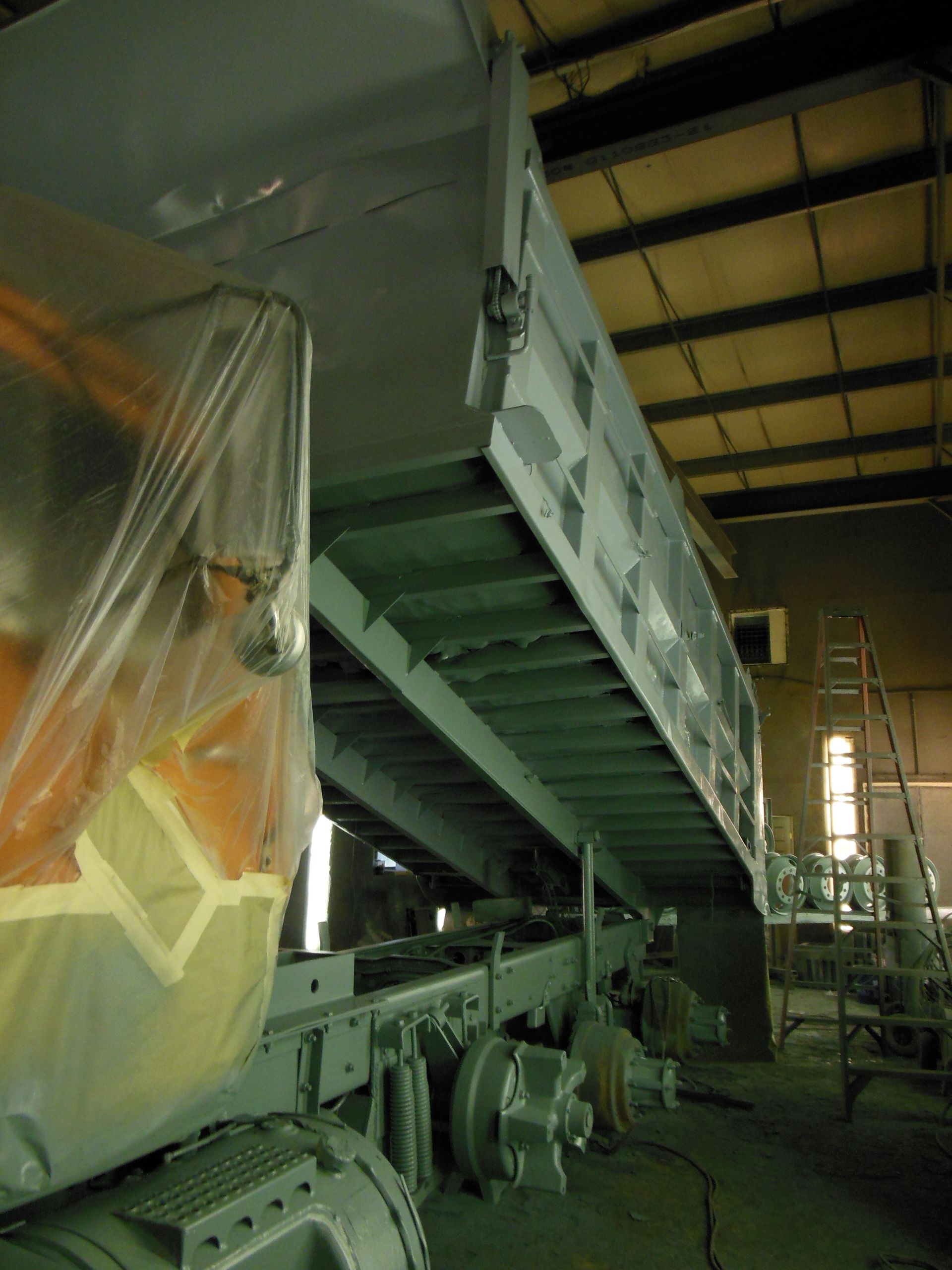 A warehouse with a lot of machinery and stairs