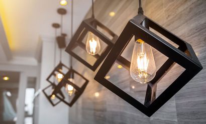 A group of pendant lights hanging from the ceiling in a room.