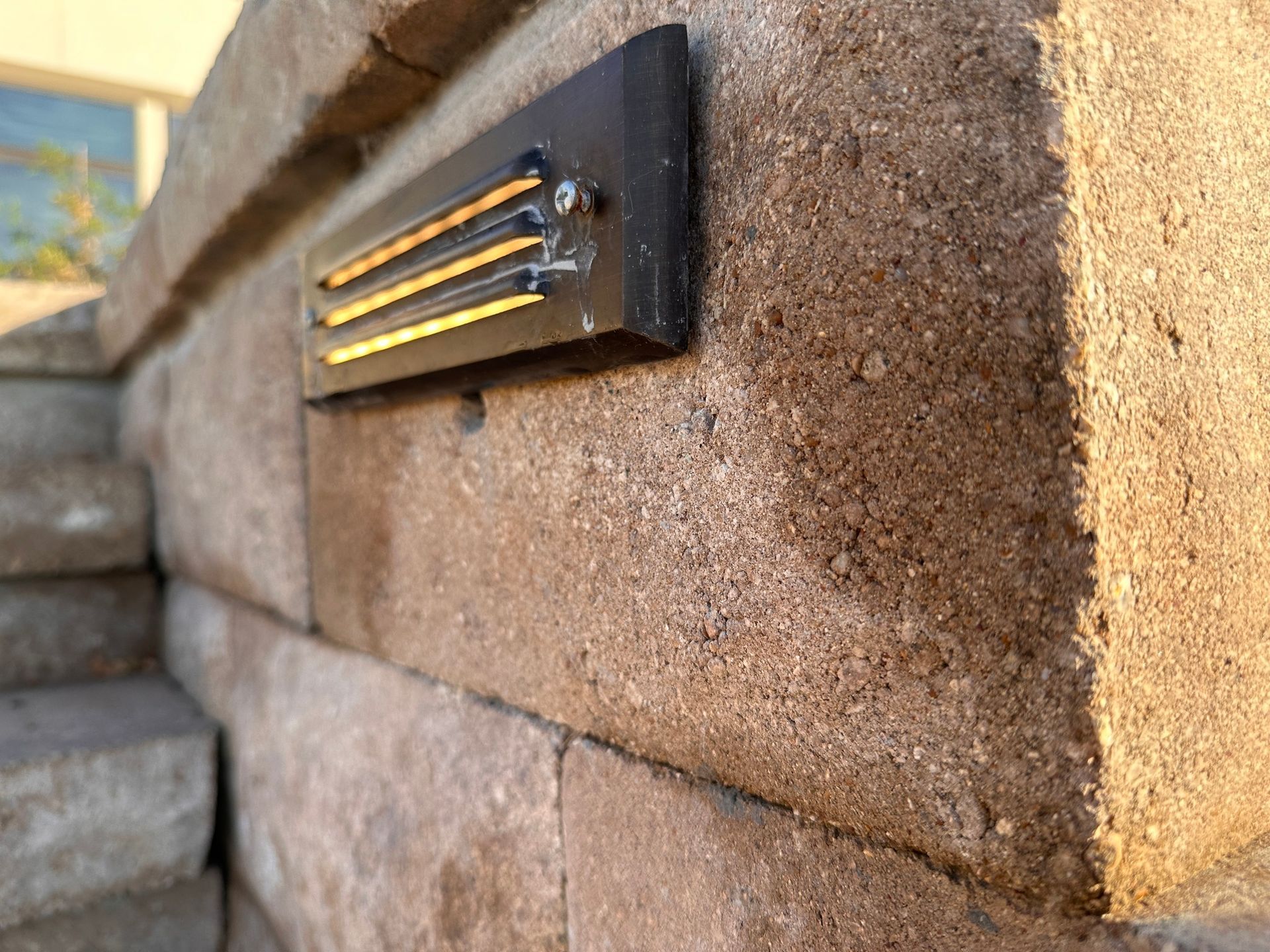 A close up of a brick wall with a light on it
