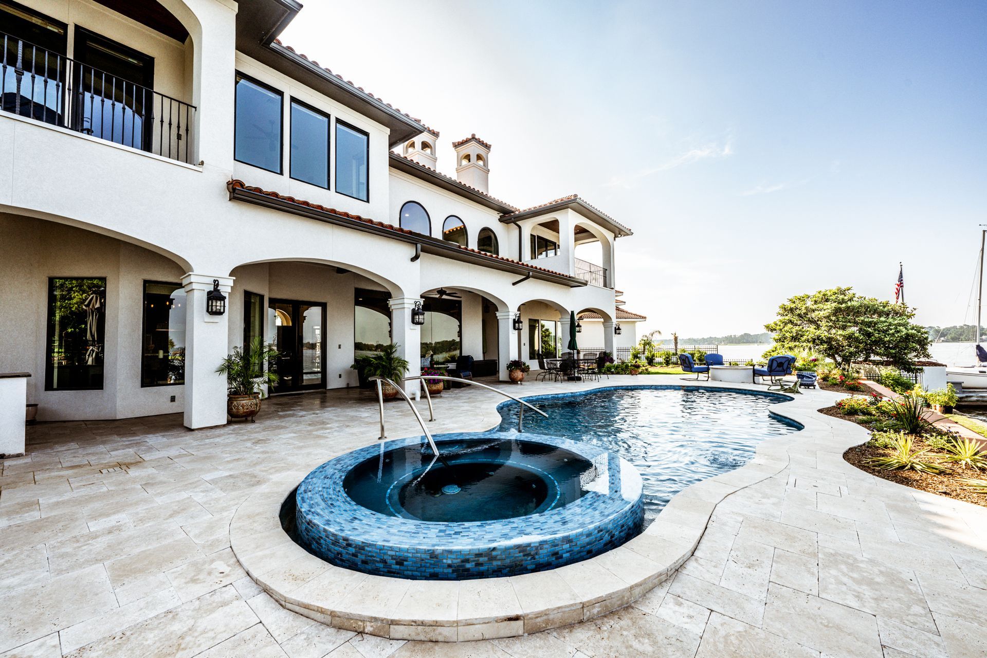 A large house with a large swimming pool in front of it