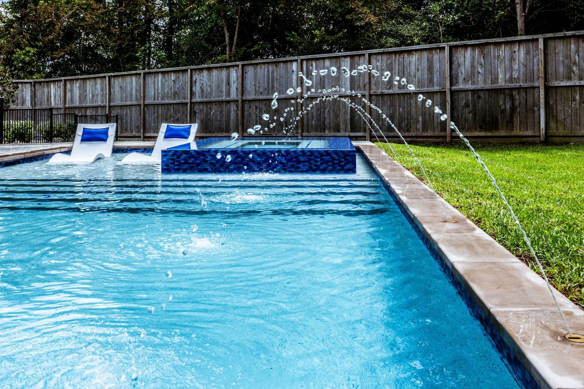 There is a fountain in the middle of the pool.