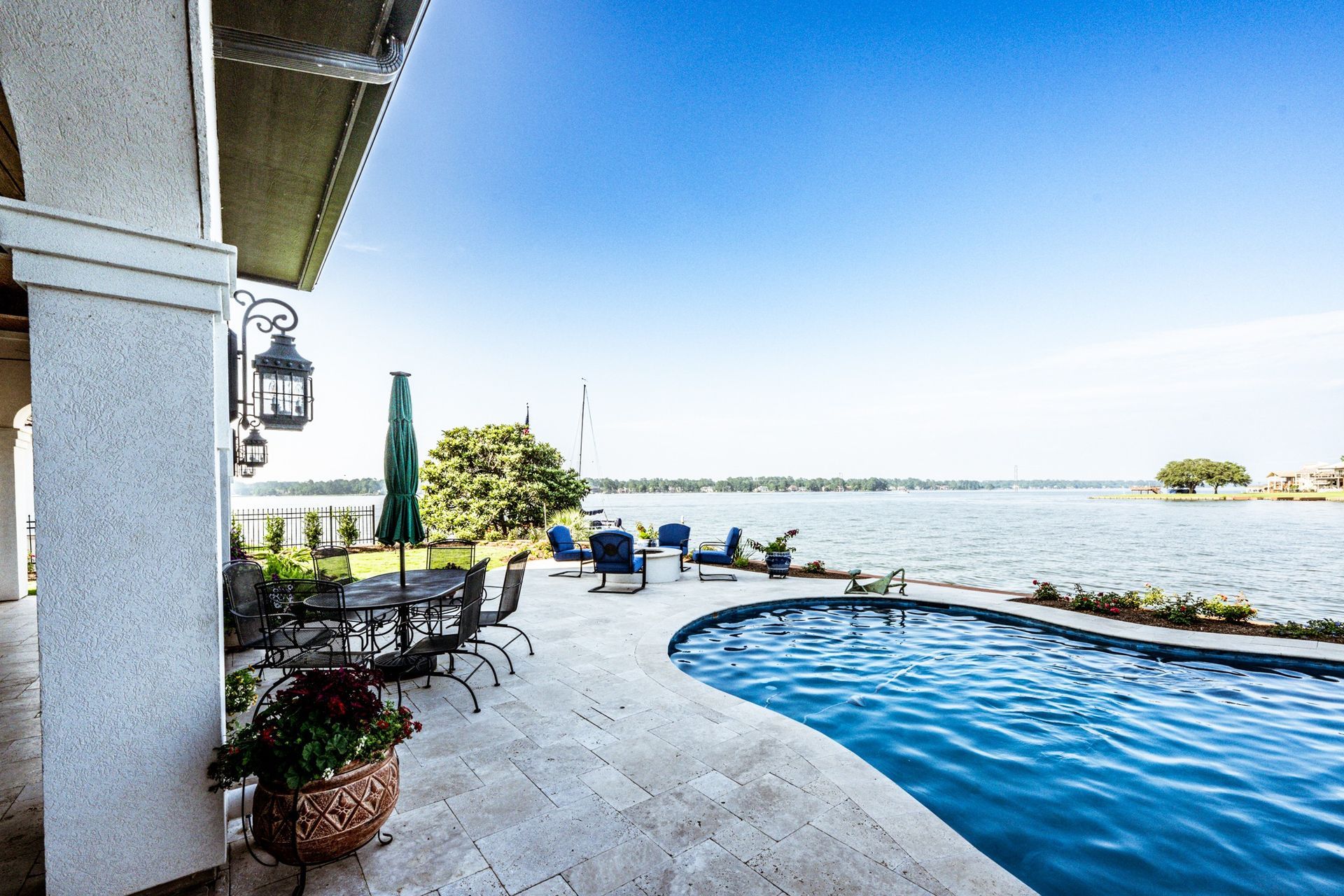 A large swimming pool with a view of a lake