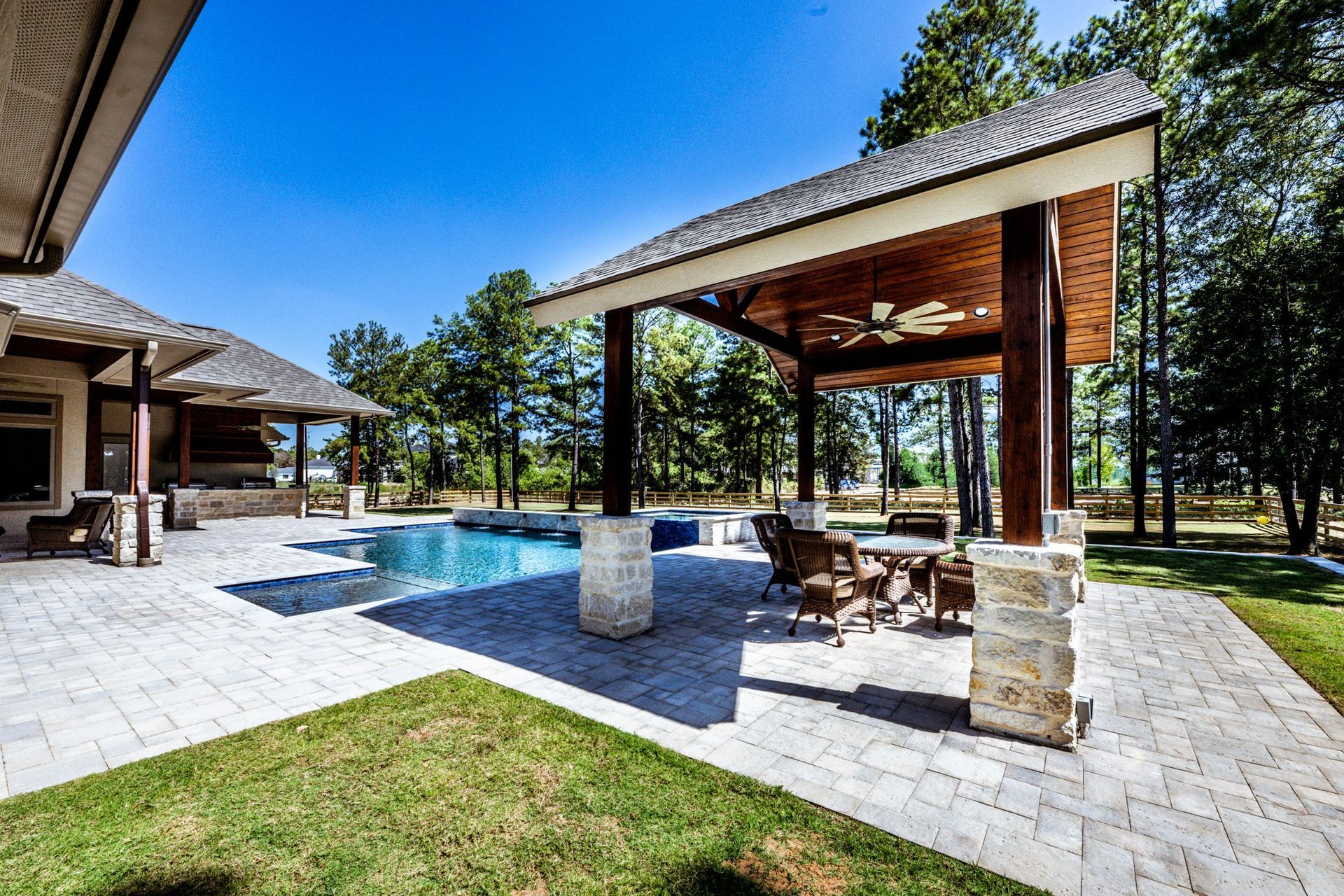 A large house with a pool and a pavilion in the backyard