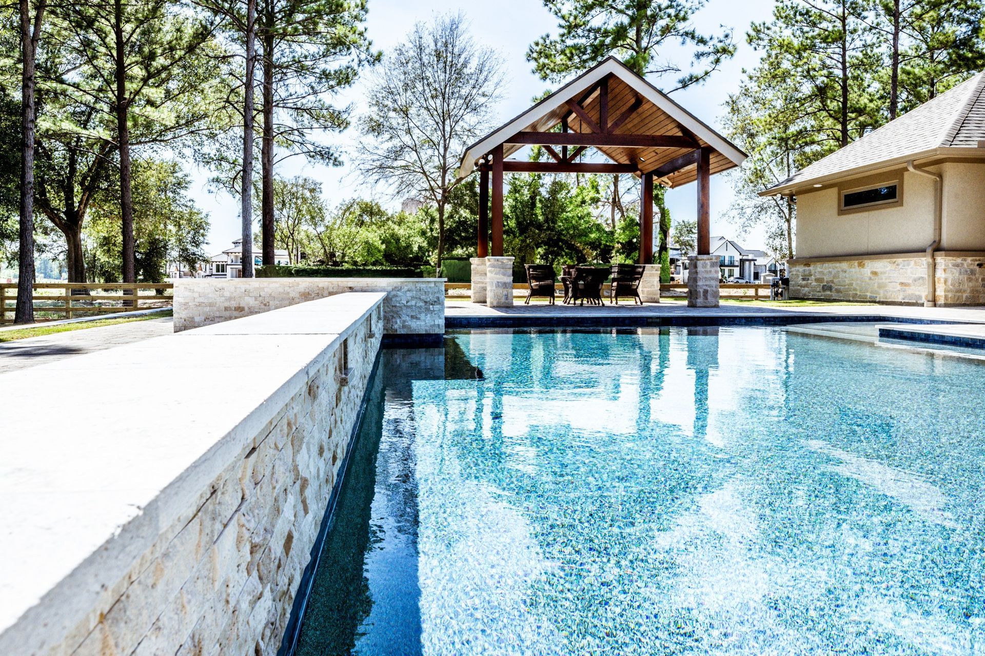A large swimming pool with a gazebo in the background.