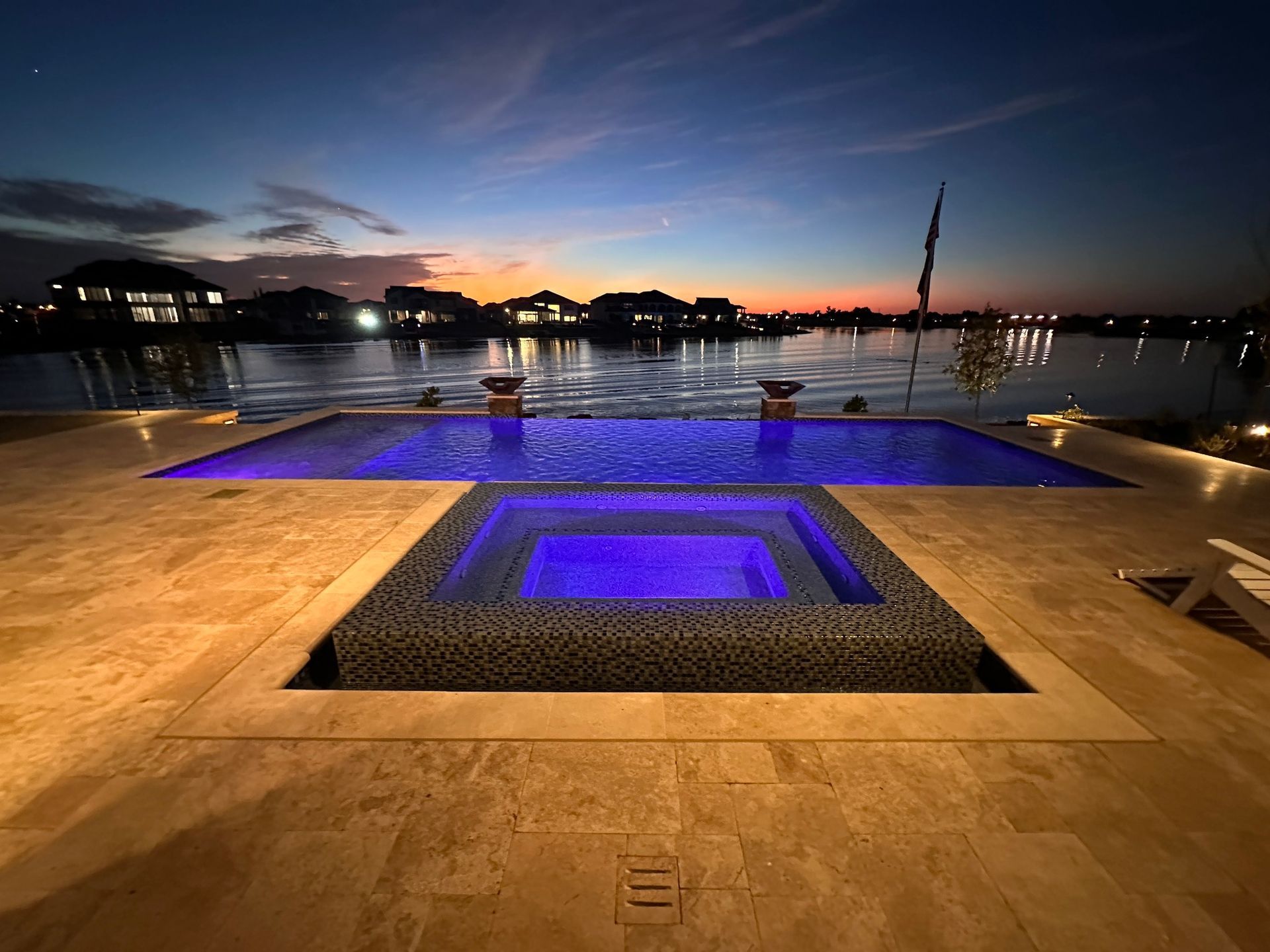 A large swimming pool with a purple light in the middle