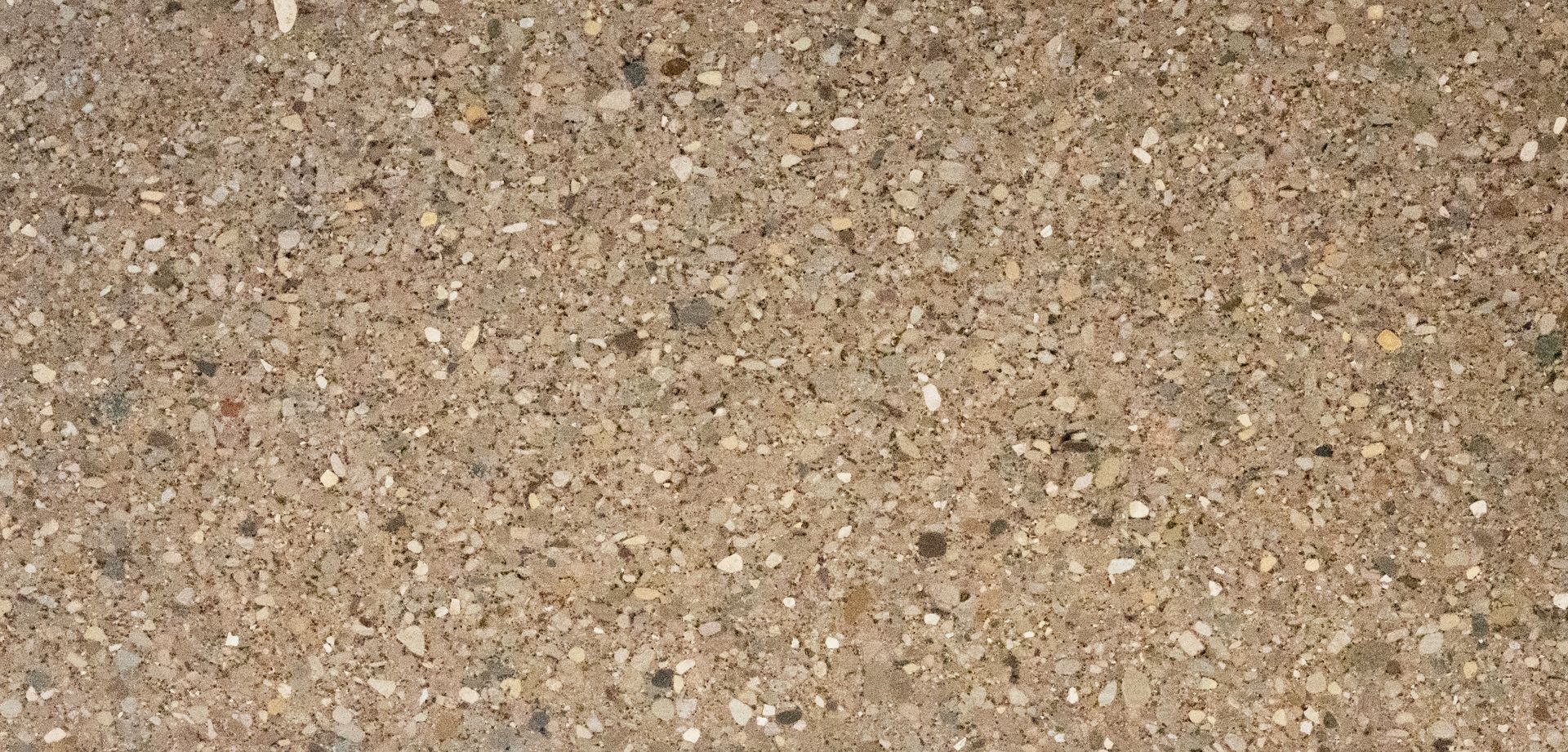 Close-up of a tan and brown speckled gravel surface