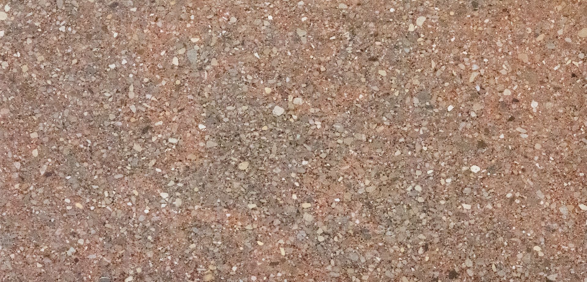 Close-up of rough reddish-brown gravel or textured stone surface