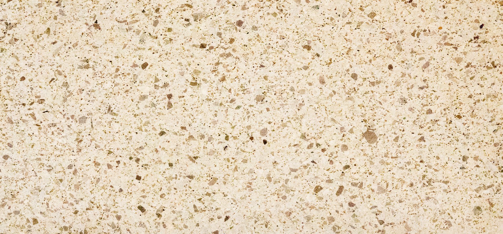 Speckled beige textured surface with small brown flecks